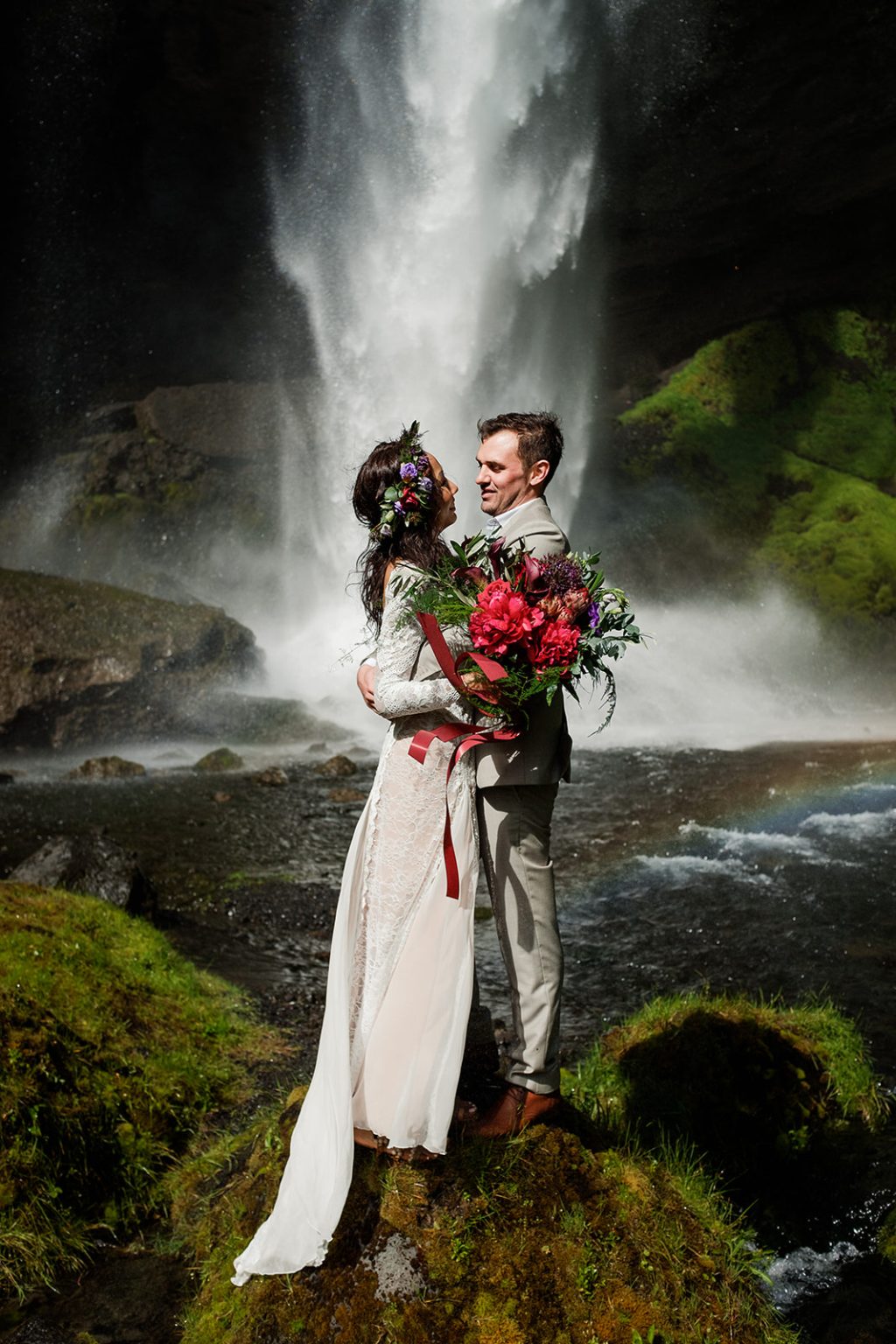 Bride with her red bouquet at Kvernufoss, South Iceland elopement