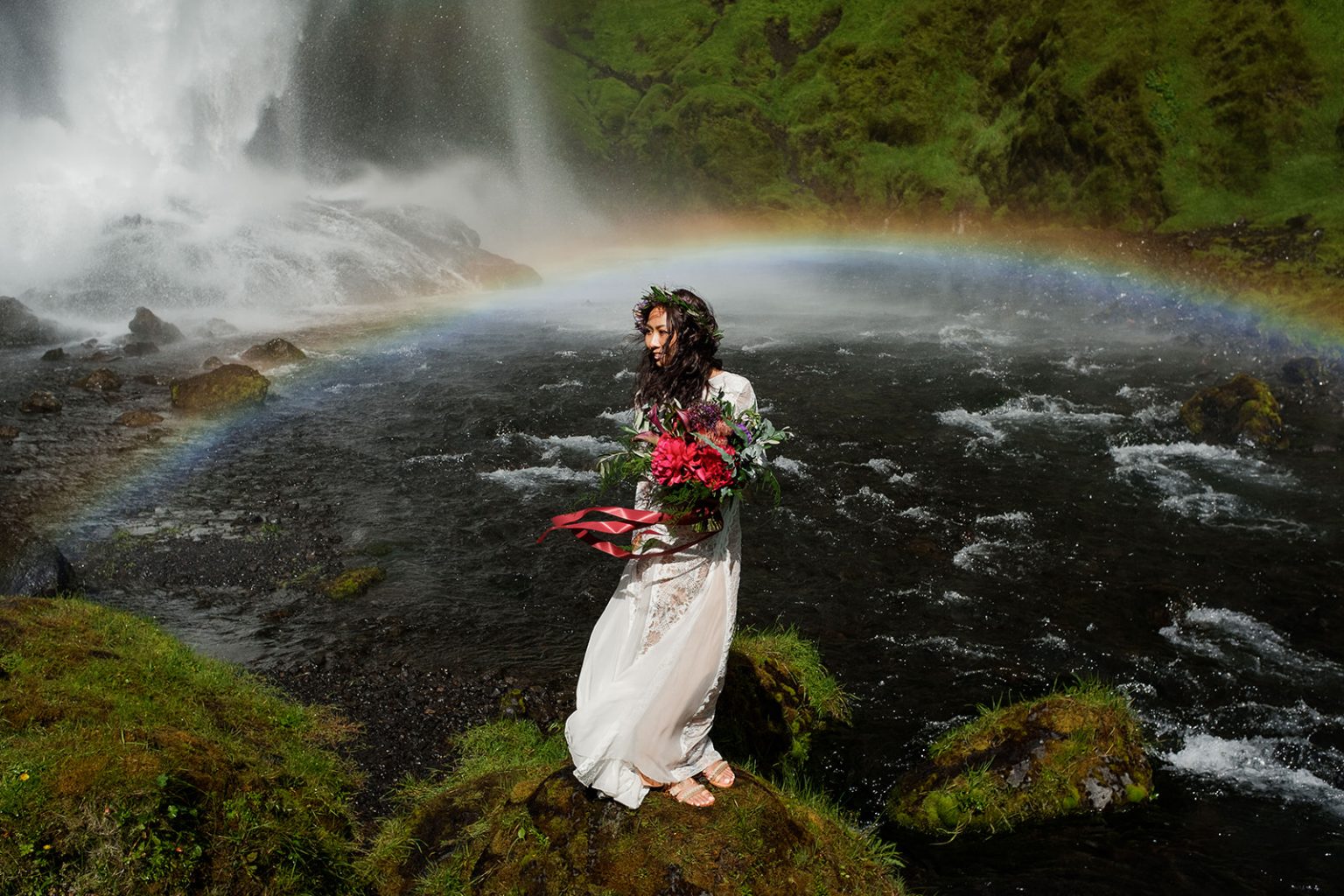 Bride with a rainbow at Kvernufoss waterfall, South Iceland elopement