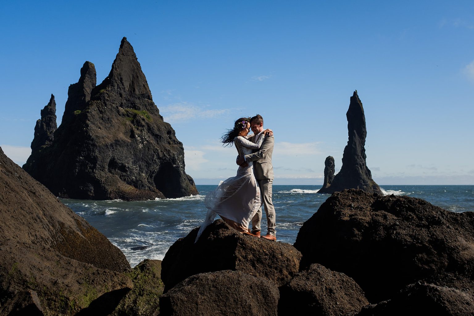 Bride on the rocks below the Reynisdrangar sea stacks, South Iceland elopement