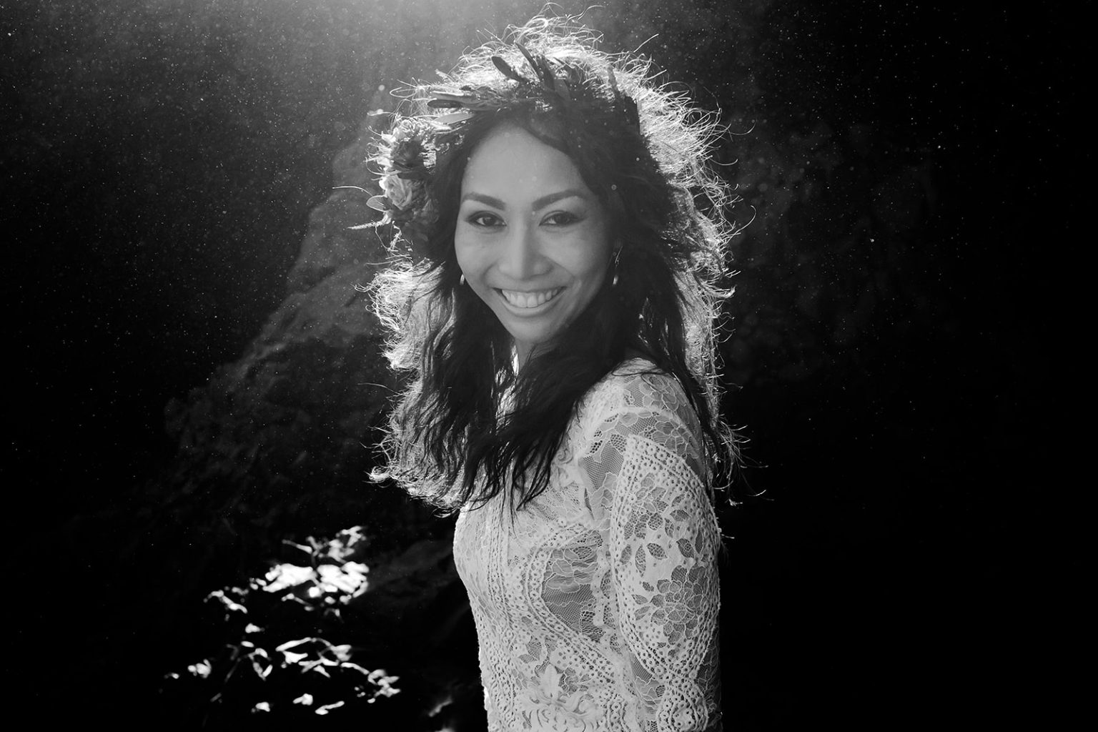 Black and white portrait of the bride in her flower crown at Reynisfjara, South Iceland elopement