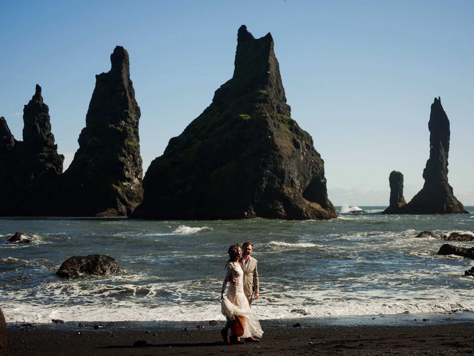 Couple beneath the Reynisdrangar sea stacks, South Iceland elopement