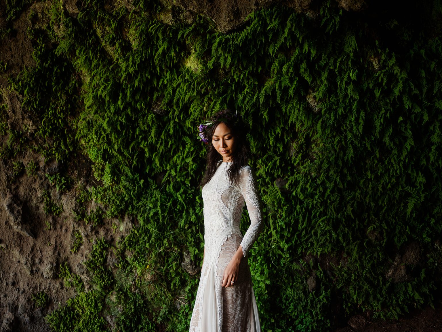 Bride in the green moss on the headland, South Iceland elopement