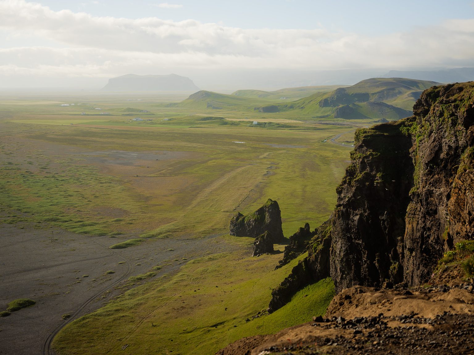 Couple on a ridge above the South Iceland coastline