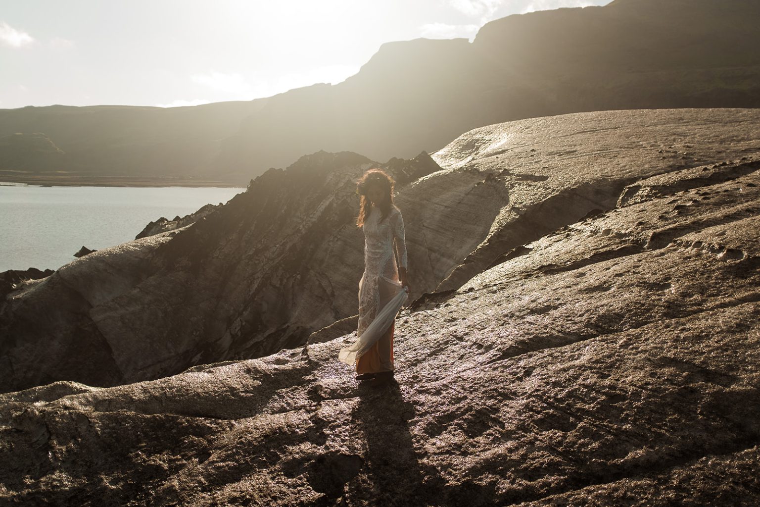 Couple walking on Solheimajokull glacier, South Iceland elopement