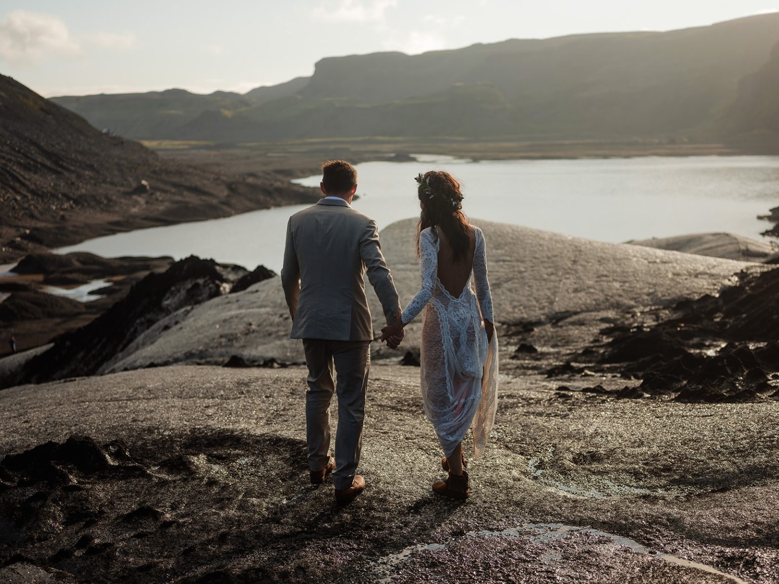 Couple holding hands on the glacier ice, South Iceland elopement