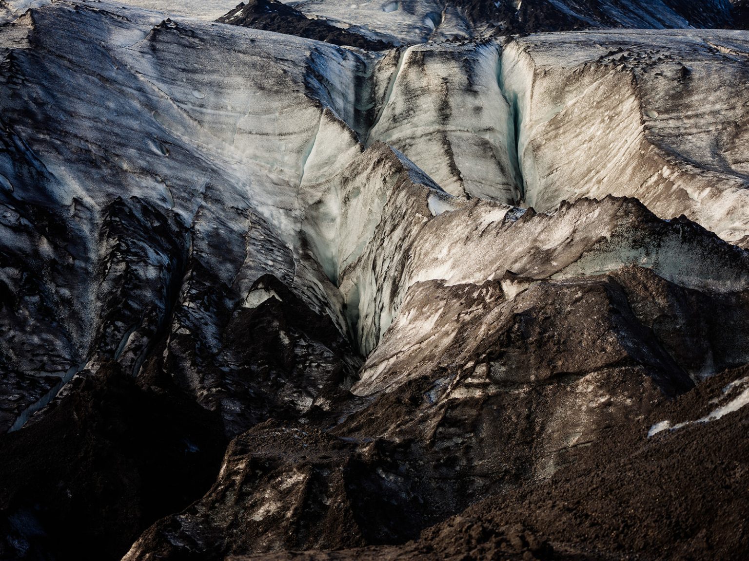 Couple among the ridges of Solheimajokull glacier, South Iceland elopement