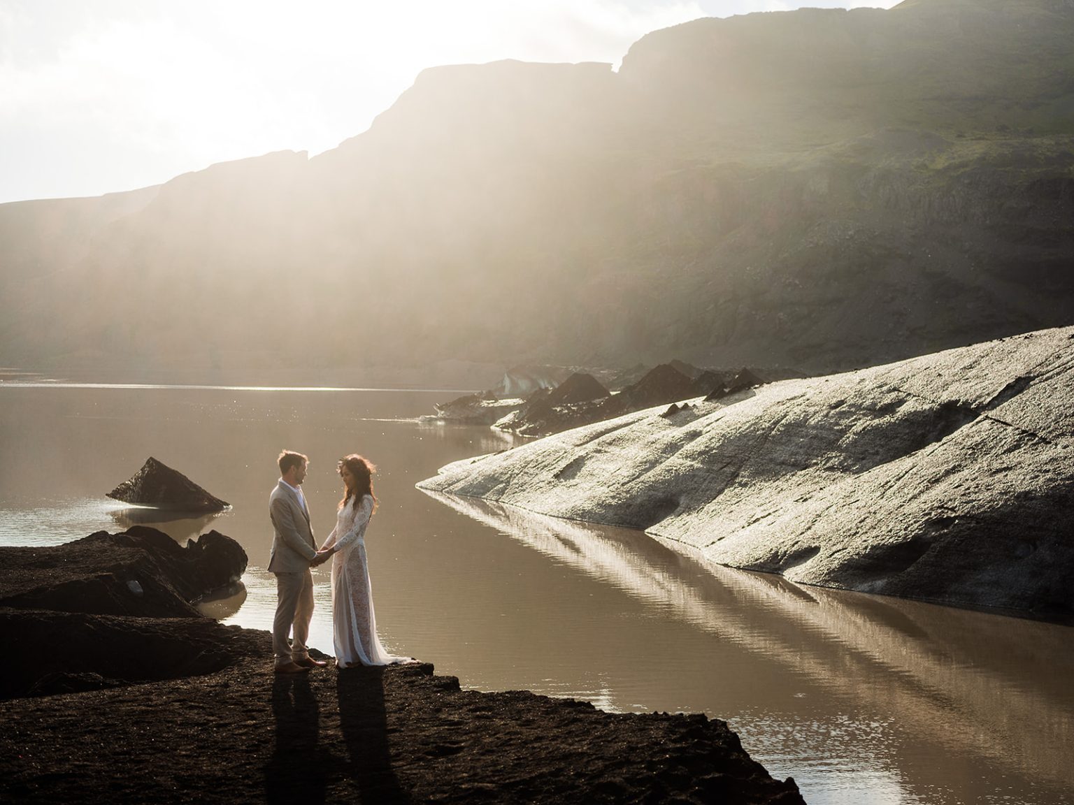 Couple reflected in still glacier meltwater, South Iceland elopement portraits