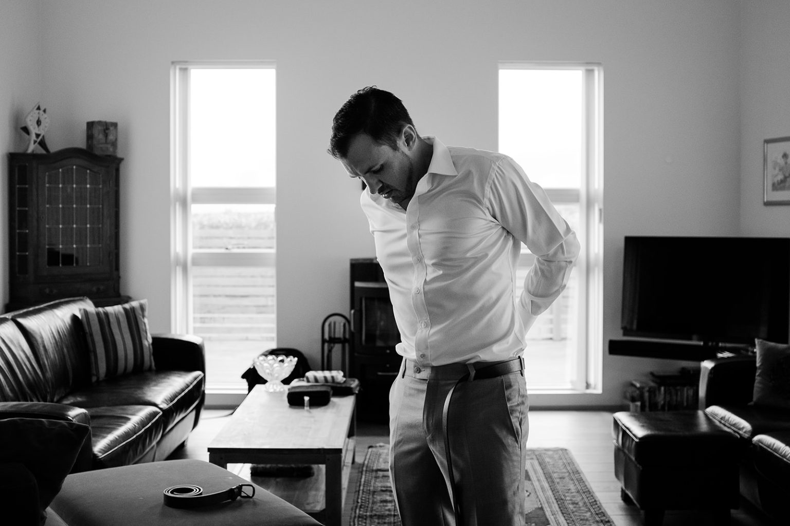 Groom getting dressed before his South Iceland elopement