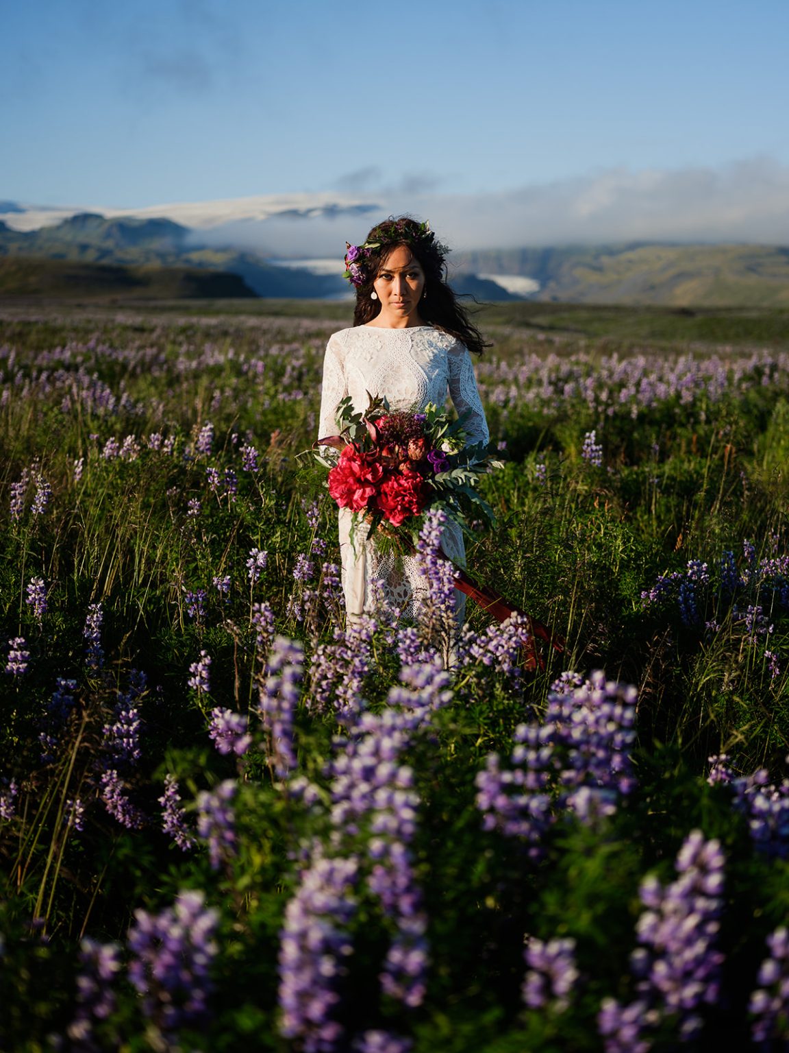 Bride in a field of lupines, South Iceland elopement portrait