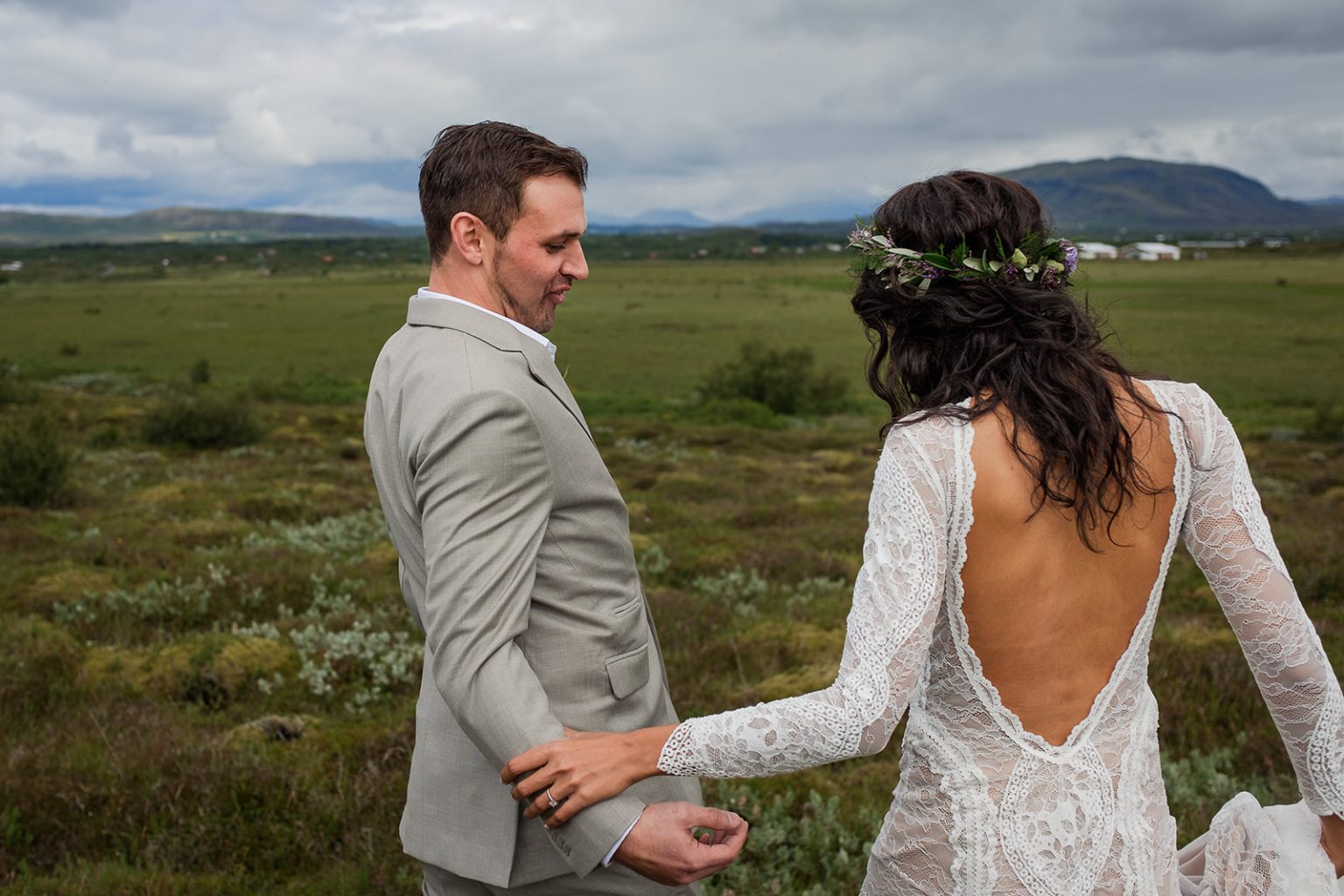 Couple in flower crowns together in an Icelandic moss field