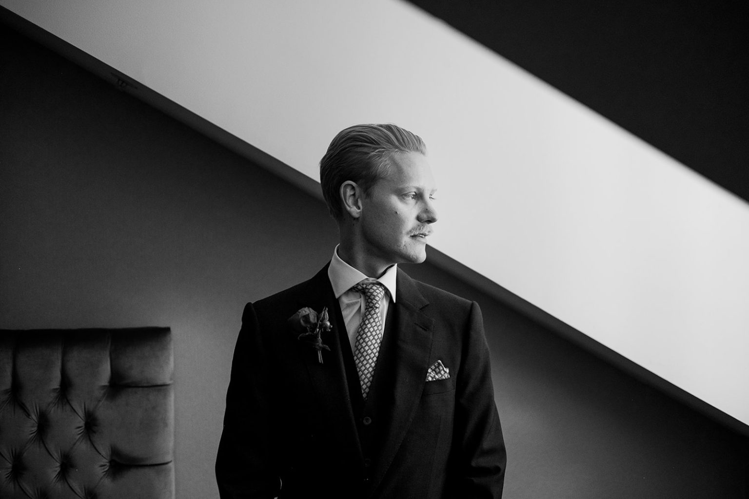 Groom portrait in window light before a Stockholm wedding