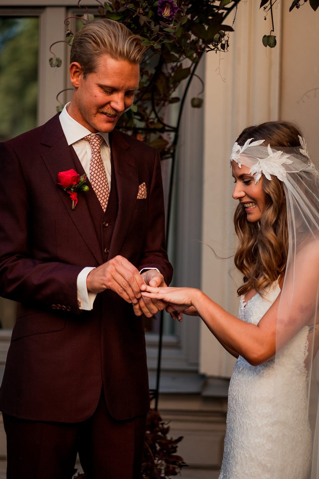 The couple together under the flowers in the courtyard