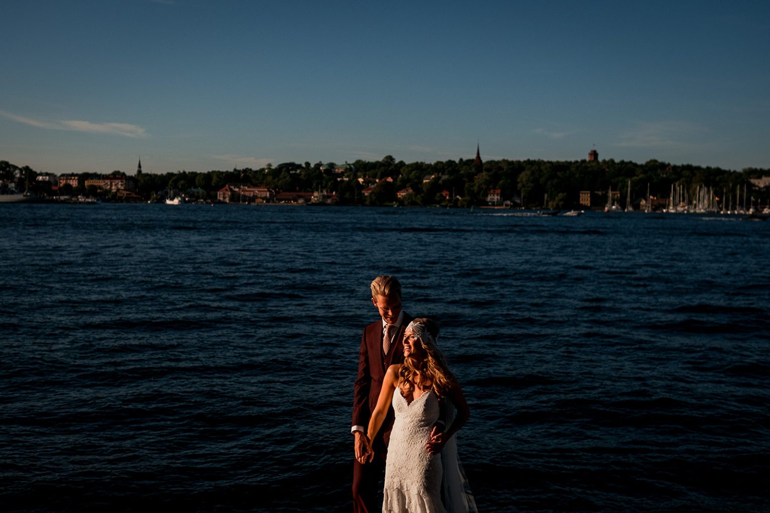The couple against the Stockholm skyline at dusk