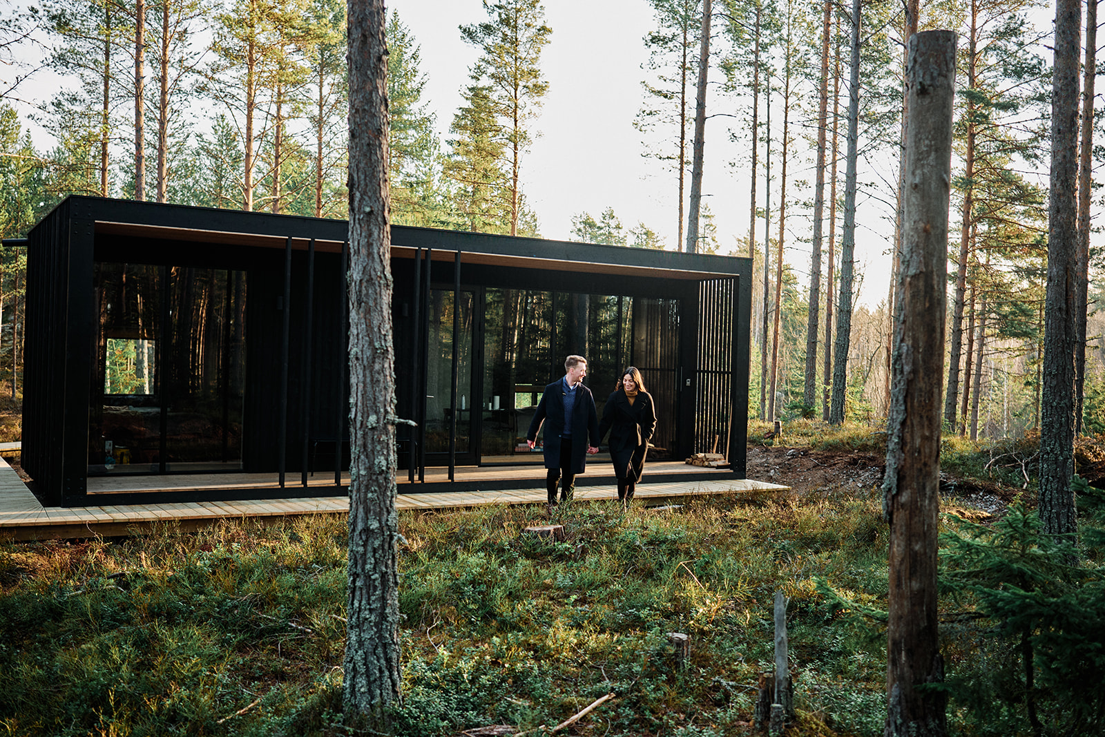 The black timber Hop Farm Beach cabin in the pine forest at Söderhamn, Sweden - Nordica Photography