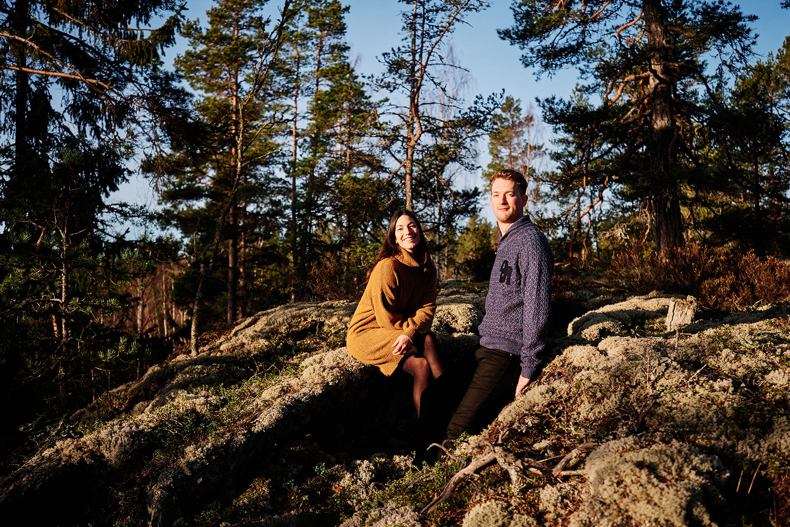 Bride-to-be on a rock in the winter forest near the Hop Farm Beach cabin, Söderhamn - Nordica Photography