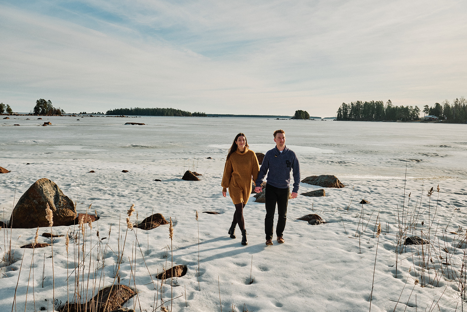 Couple walking the snowy Baltic archipelago at Söderhamn, Sweden - Nordica Photography