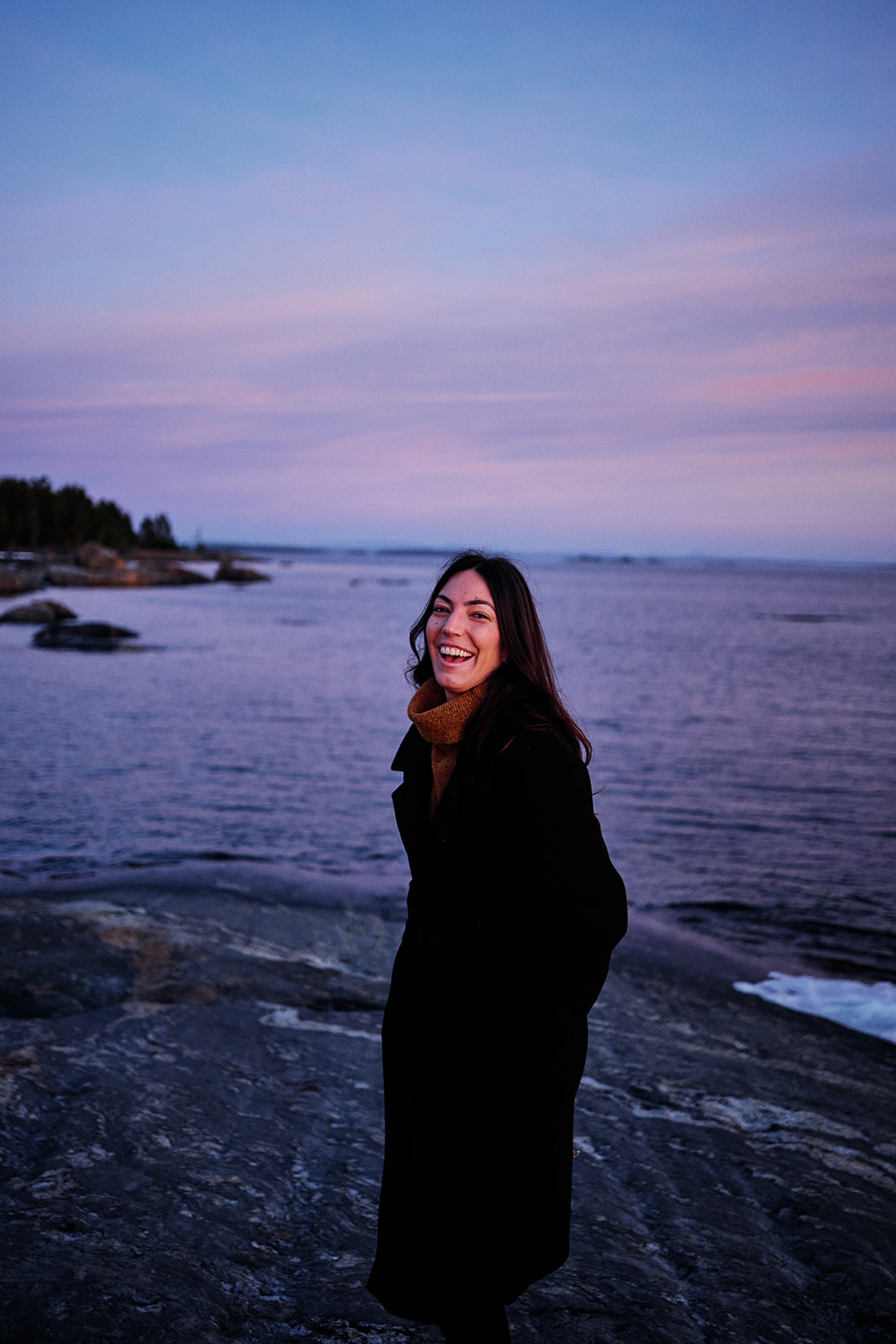 Bride-to-be laughing in the winter dawn light on the Baltic coast at Söderhamn, Sweden - Nordica Photography