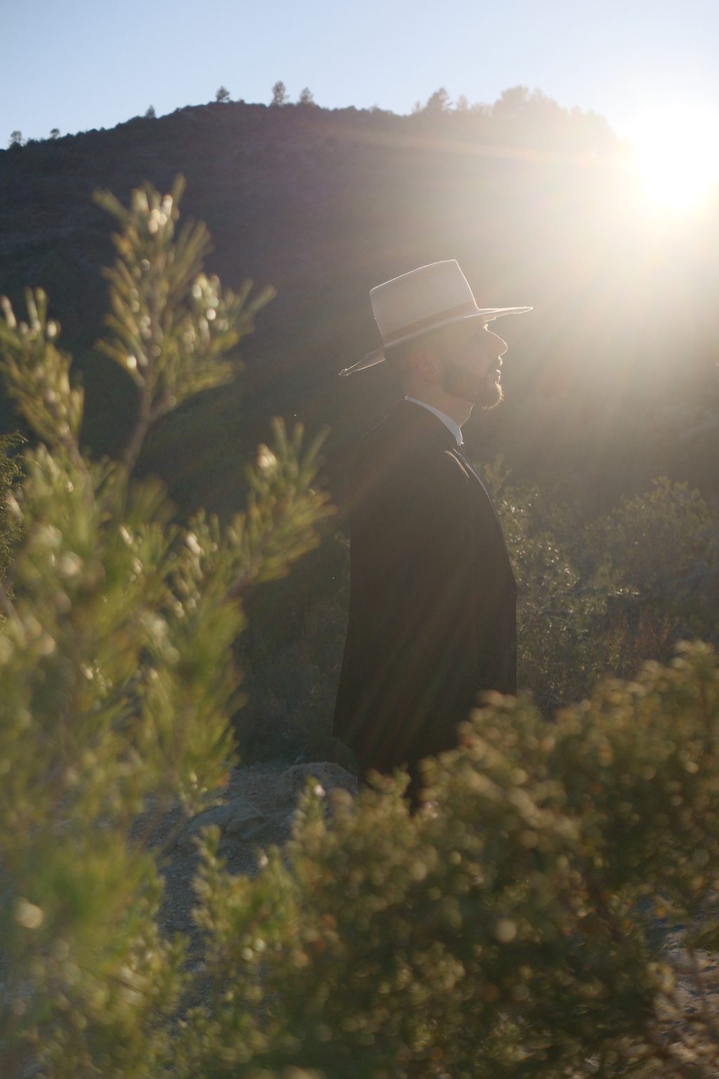 Ondrej backlit among olive branches in the Valencian hills