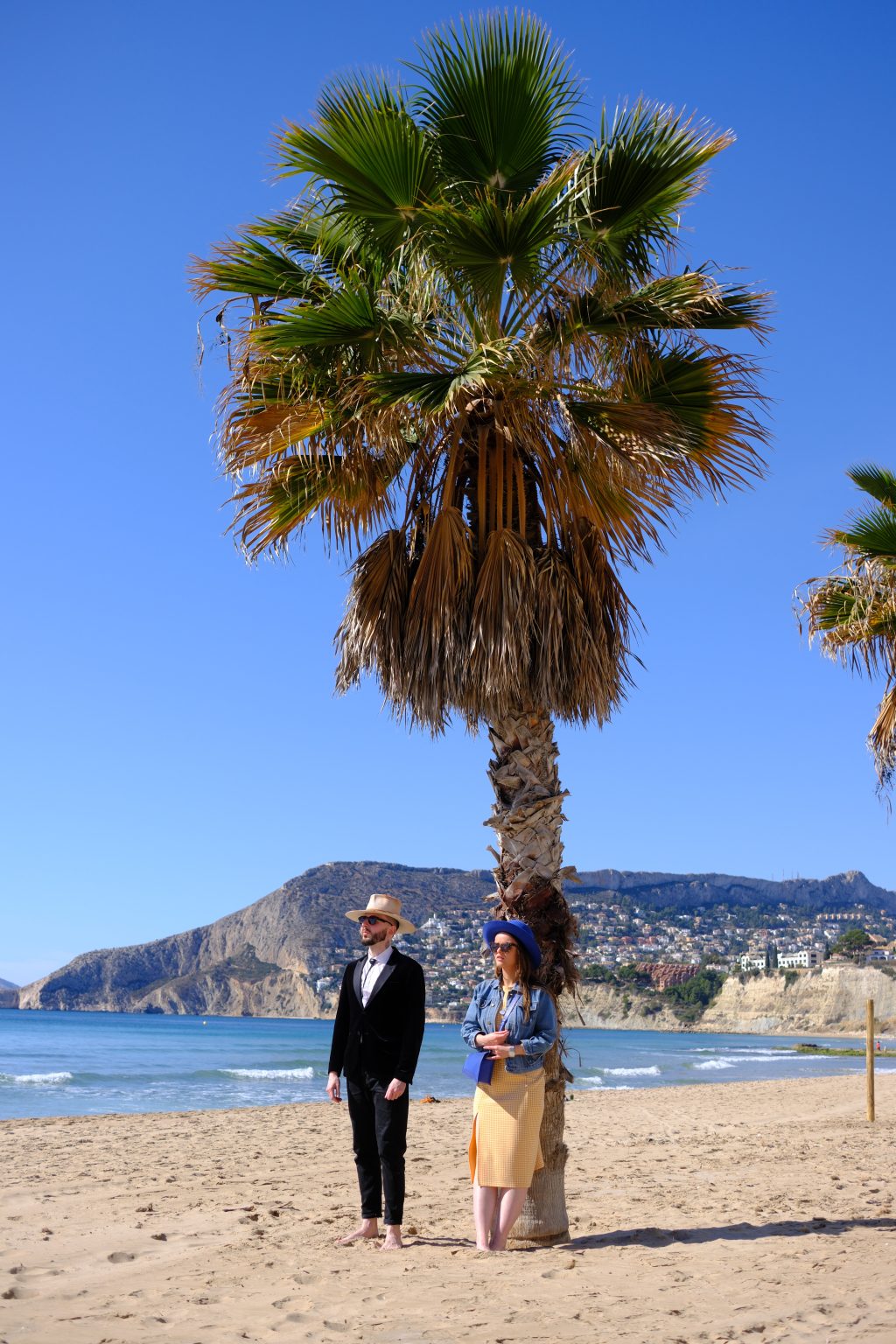 Under a palm on Calpe beach with the Peñón de Ifach behind, Spain
