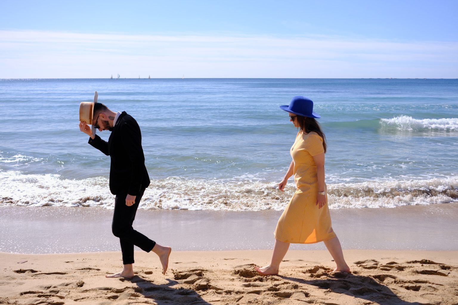 Bride in a yellow dress walking the sand at Calpe on the Valencia coast