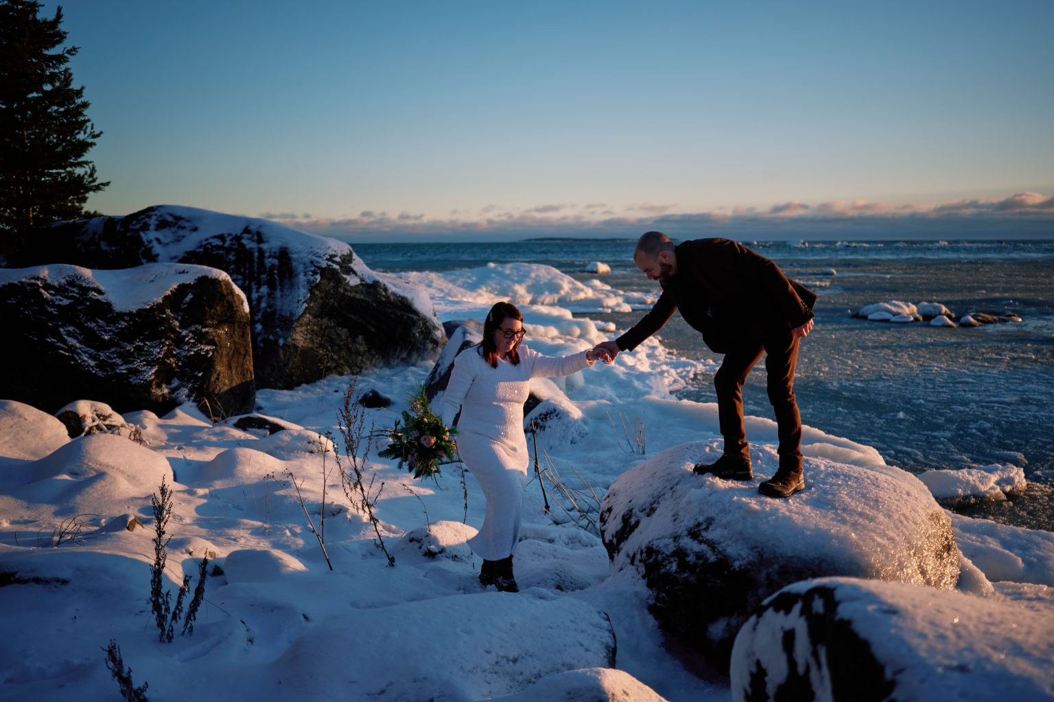 Sam and Rob on the rocks as the sun comes out, the Bothnian coast