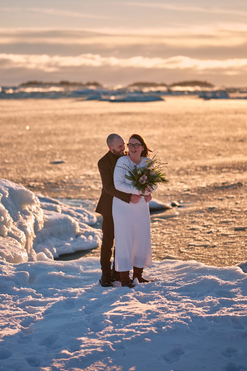 The couple in a field of untouched snow, winter elopement Sweden