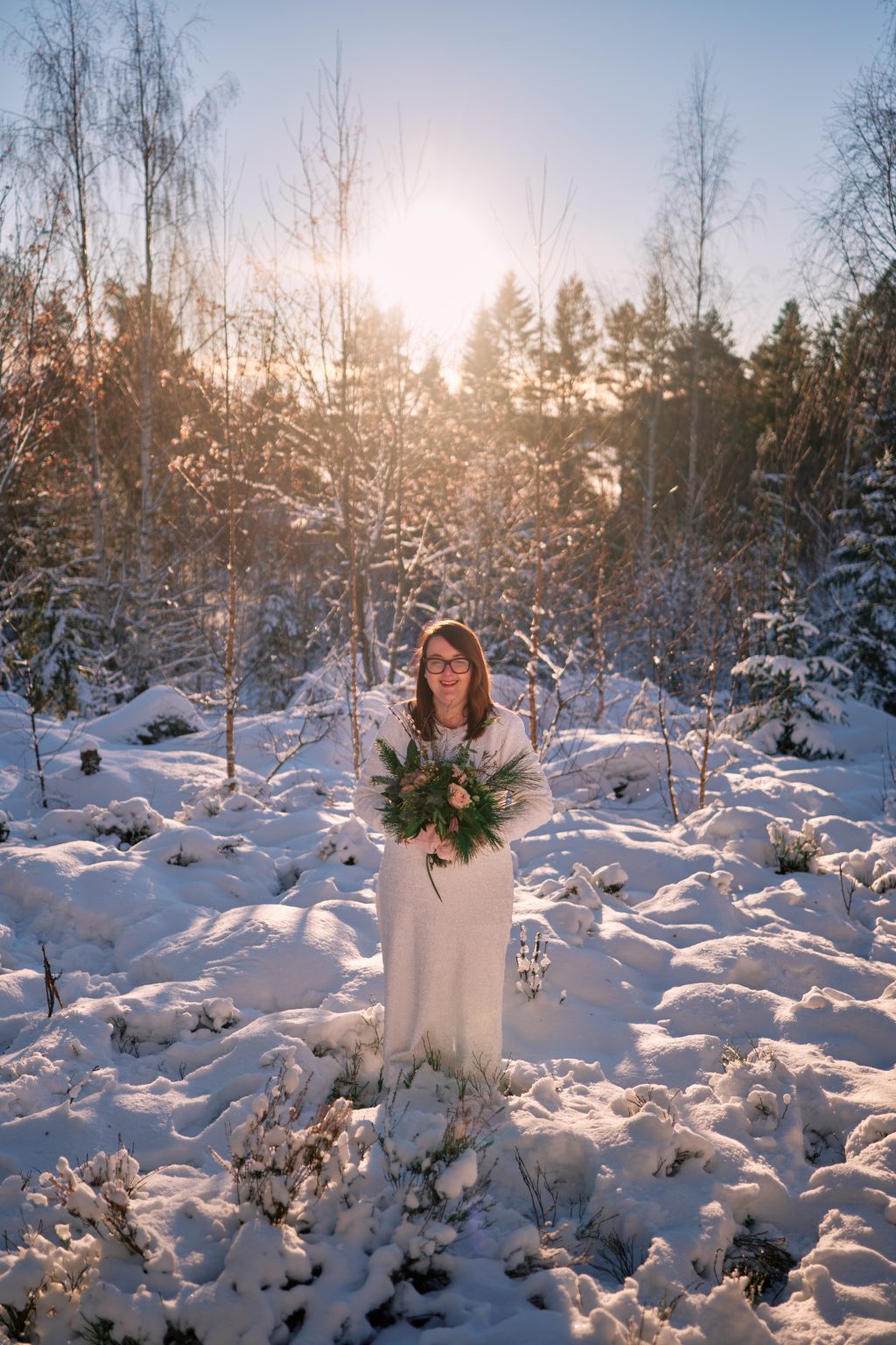 Sunlit pines heavy with snow, a Scandinavian winter