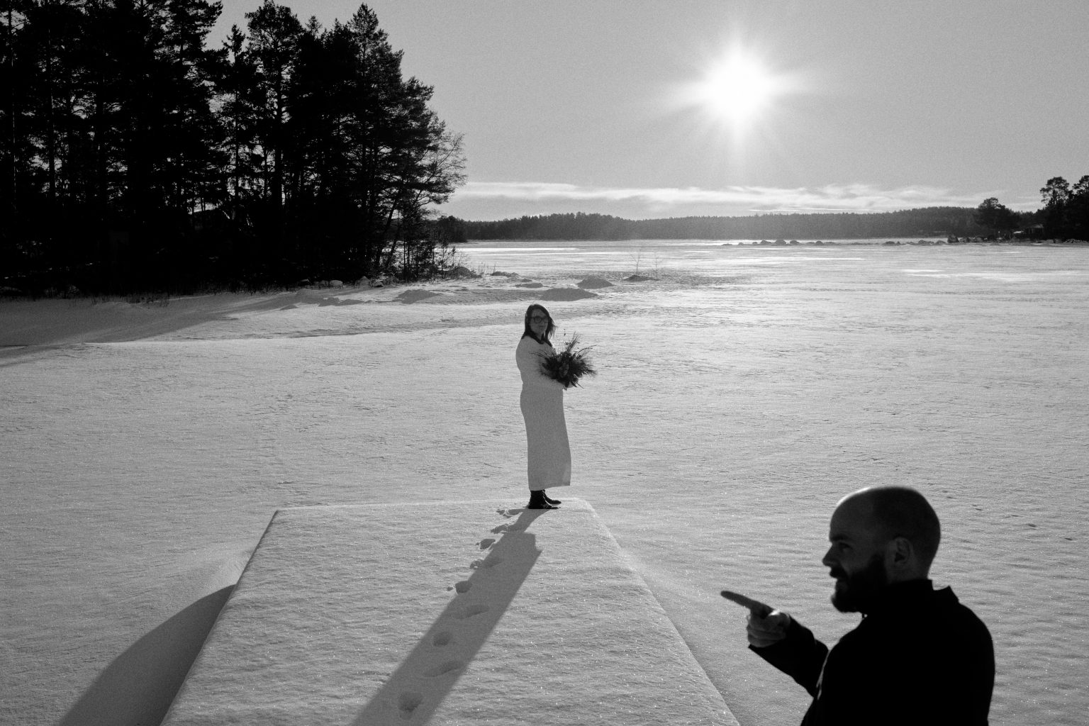 The bride on the frozen sea in black and white, winter in Sweden