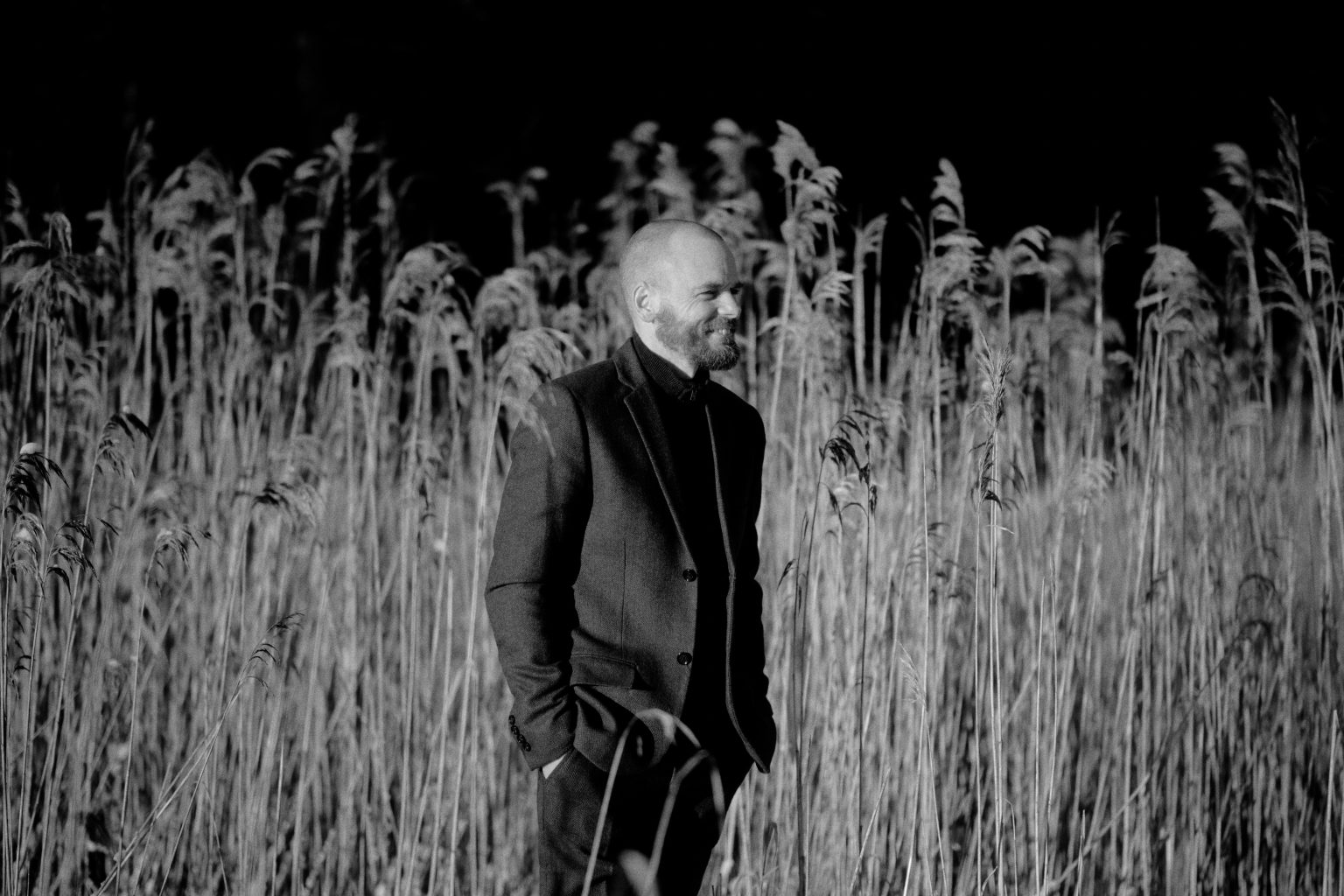Black and white portrait of the groom in the winter reeds, Sweden