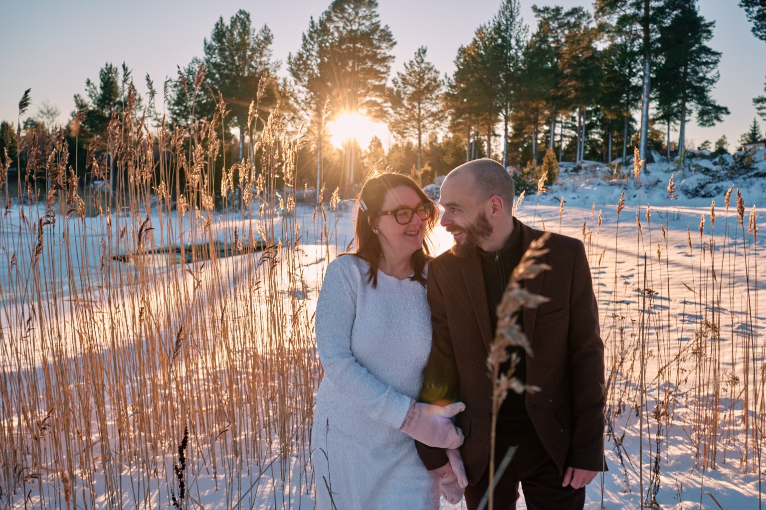 Sam and Rob in the golden winter reeds, elope in Sweden