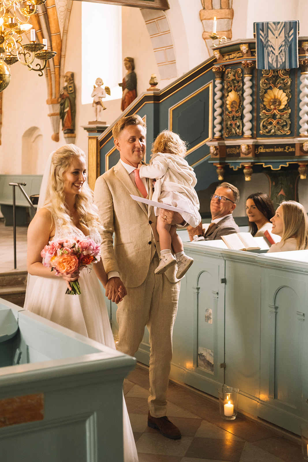 The couple and their family at the altar