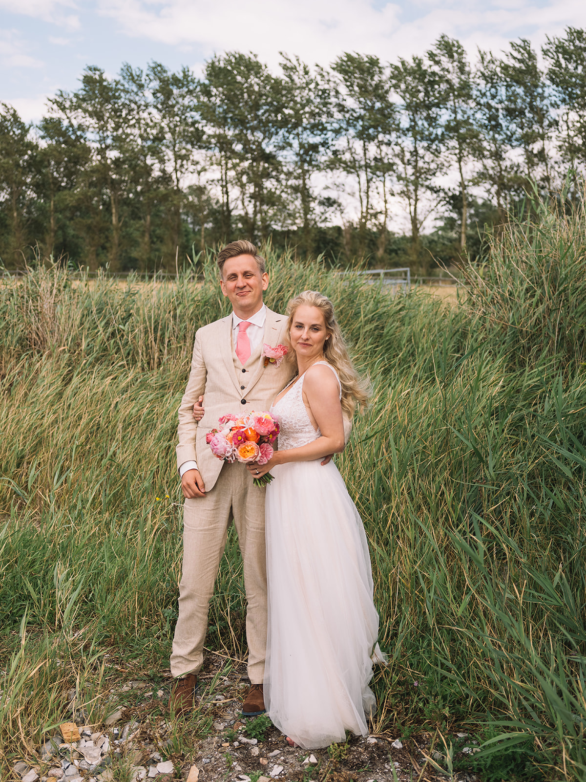 The couple in the tall grass by the shore at Lomma