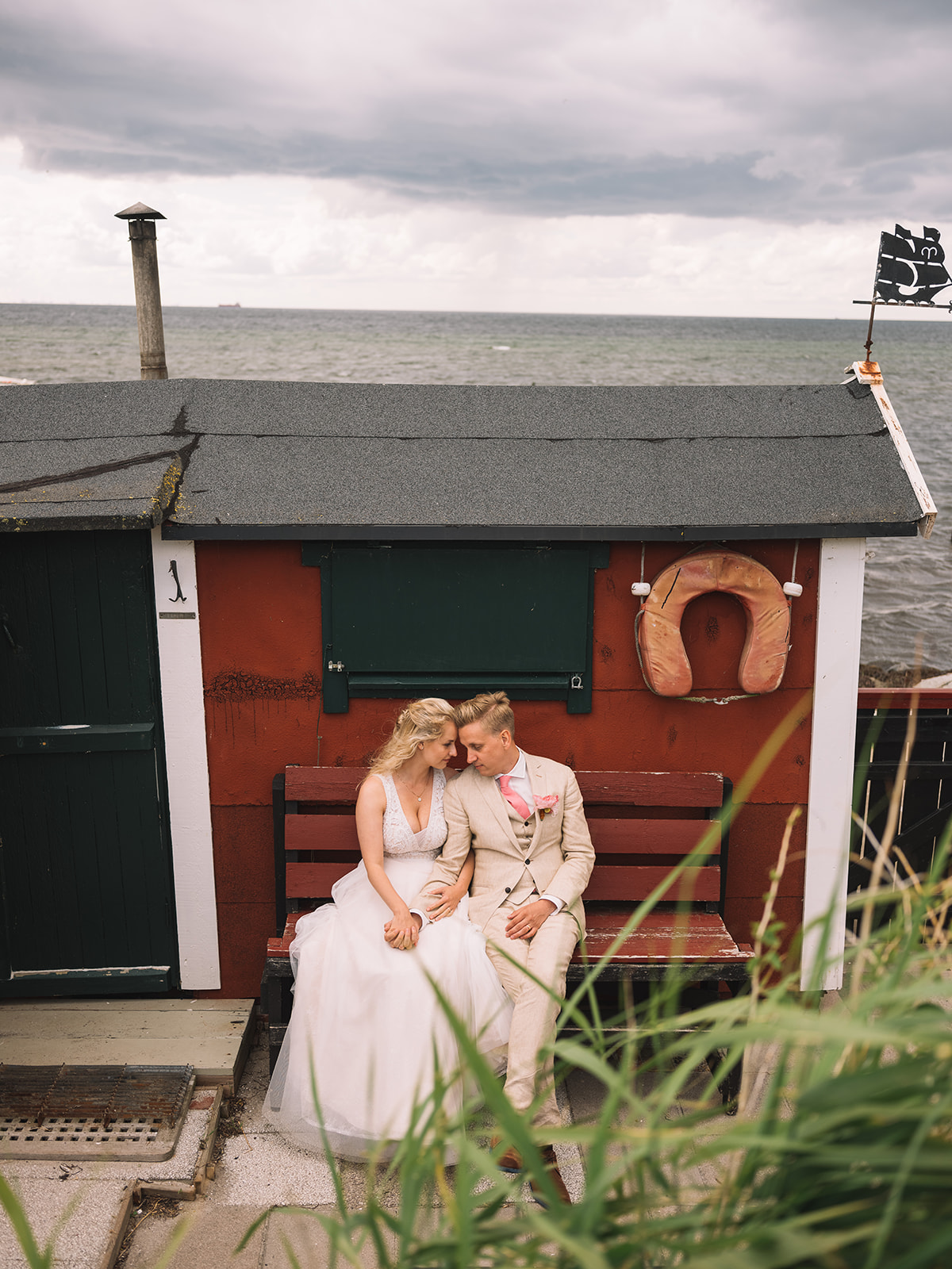 The couple by a red beach hut at Lomma