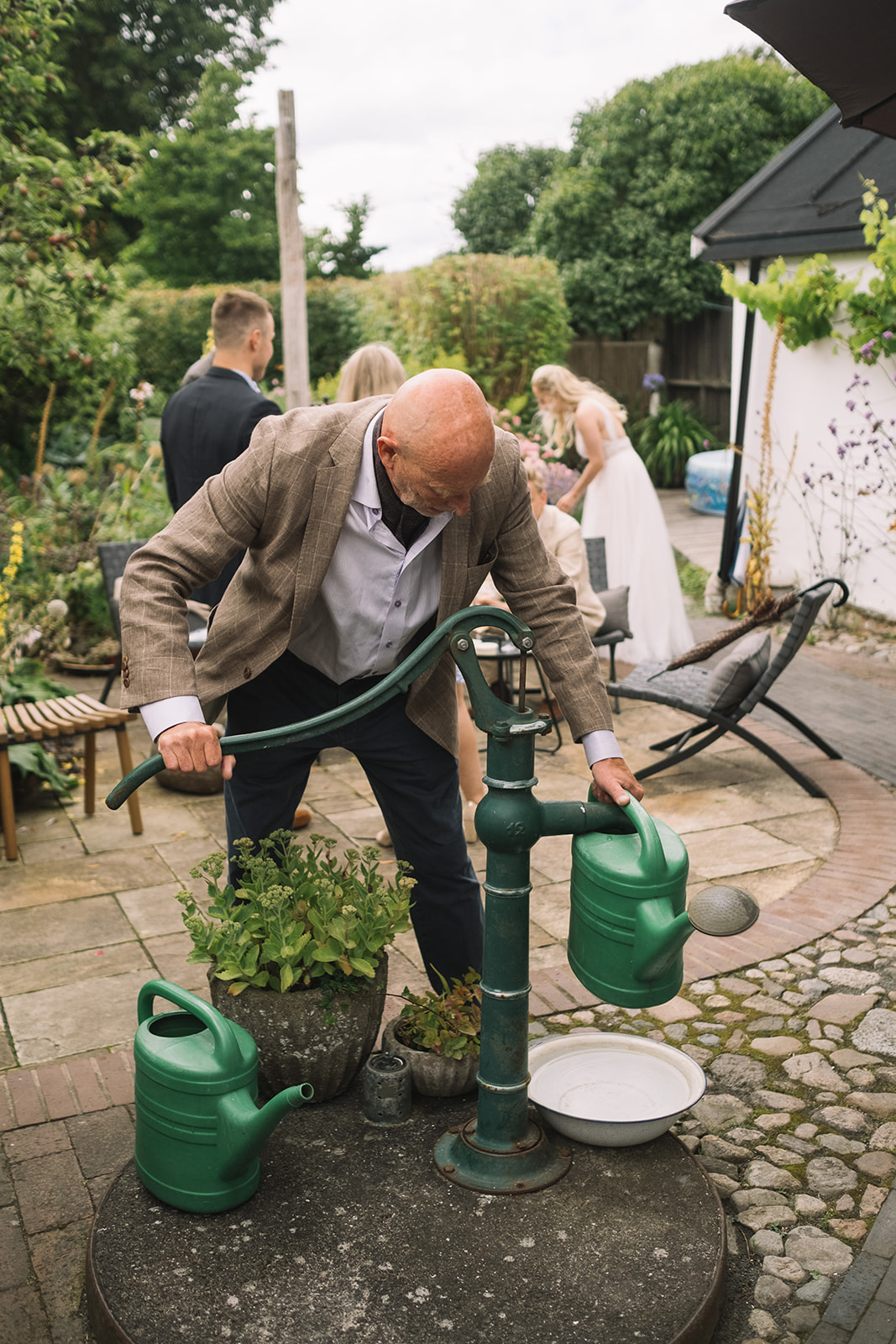 Filling the watering cans during the wedding party