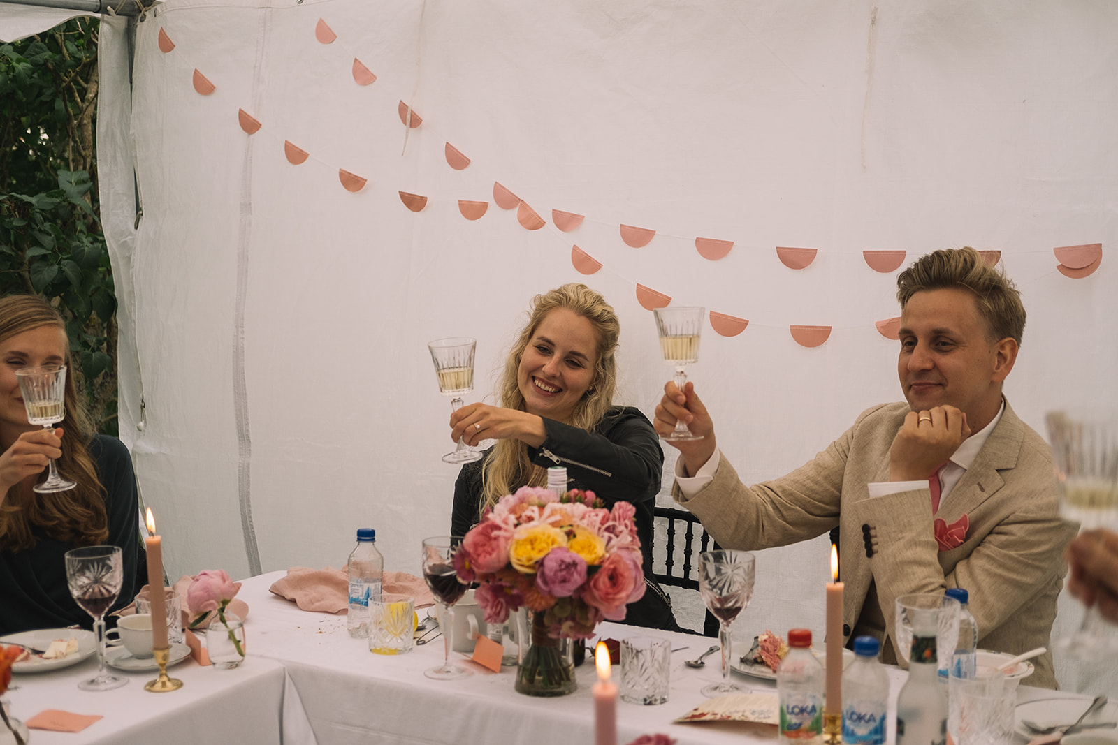 A toast at the wedding table in the garden