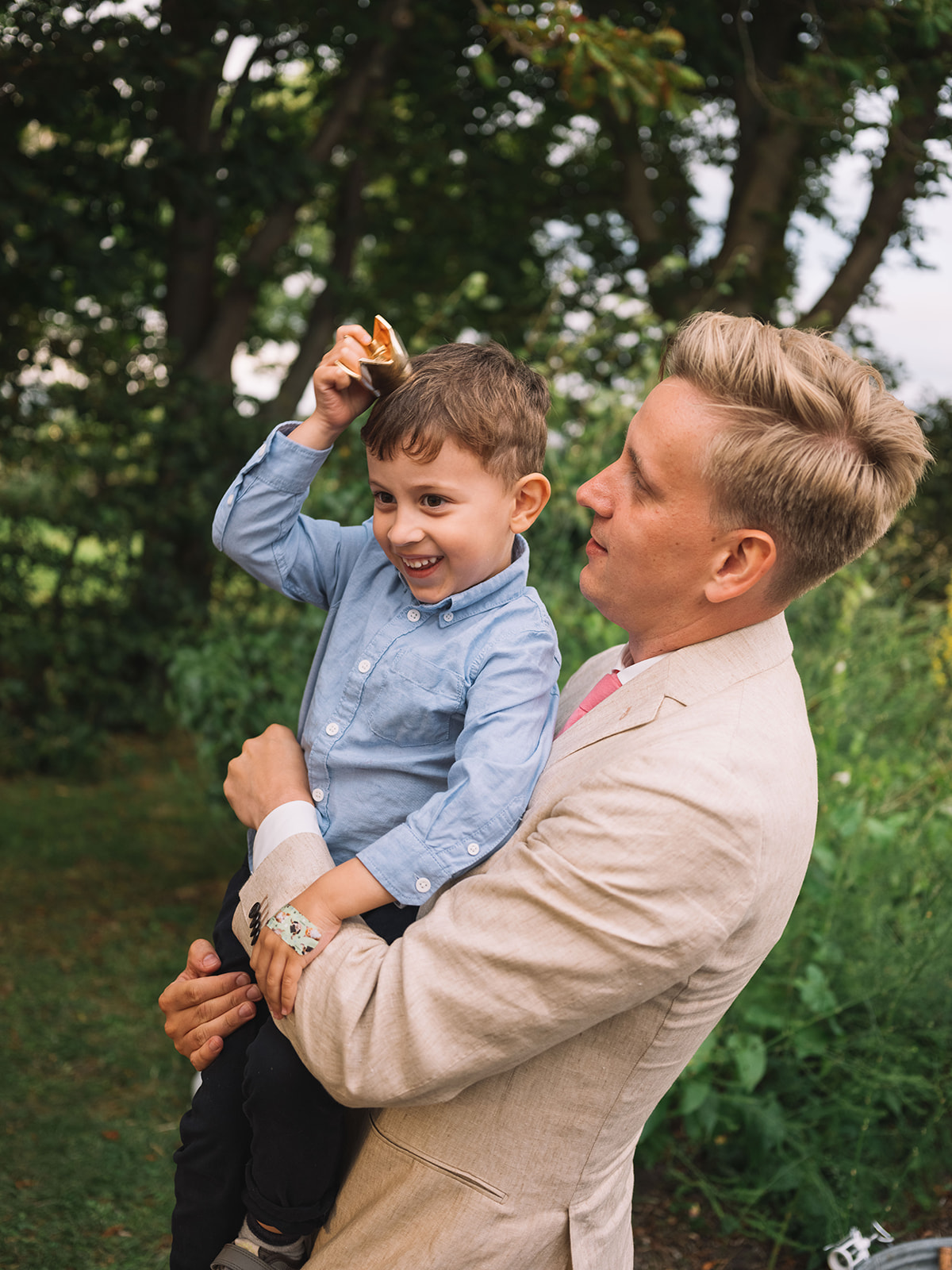 A guest lifting a boy onto his shoulders