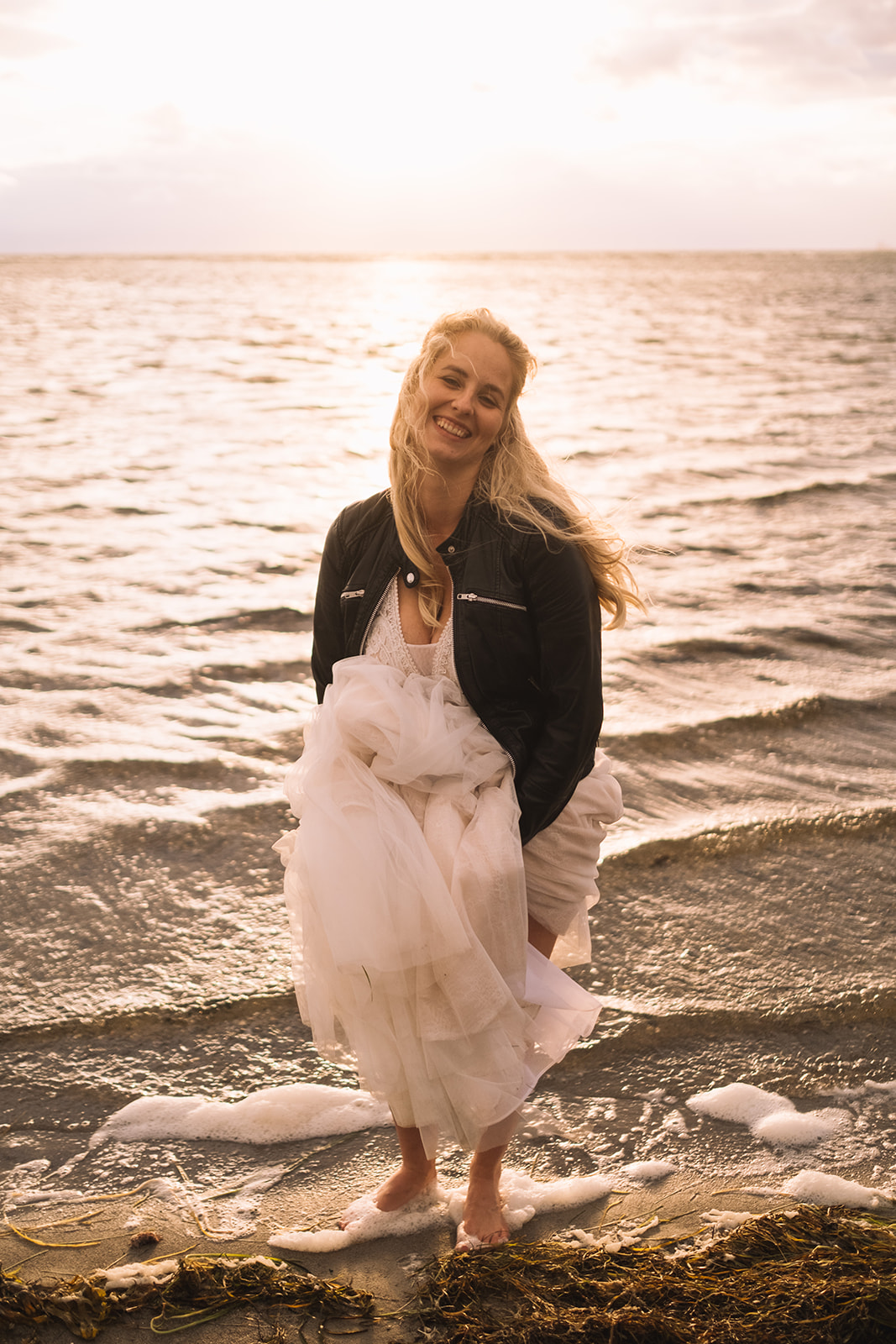 Alice at the water’s edge in her wedding dress