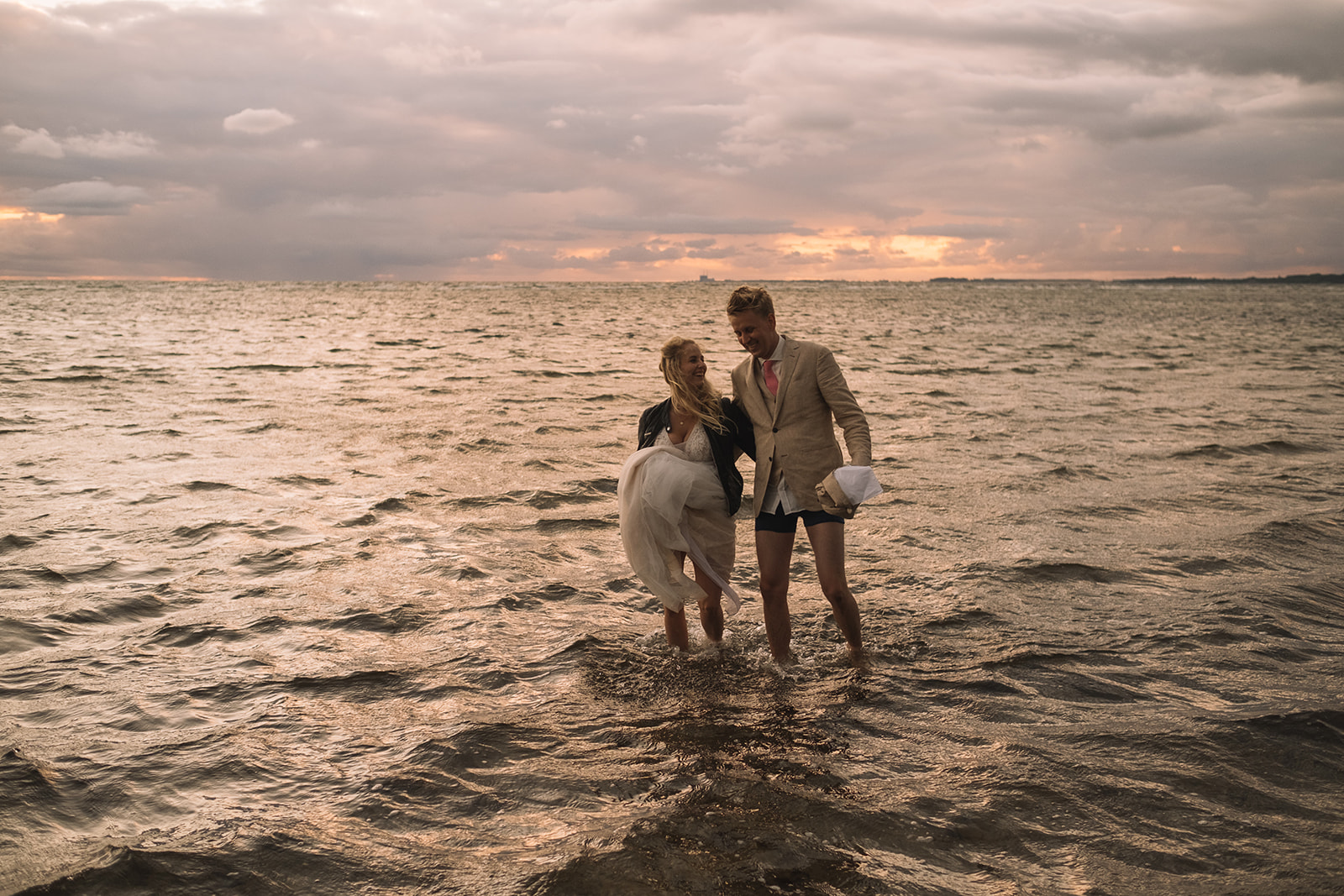 Alice and Marcus walking out into the water together
