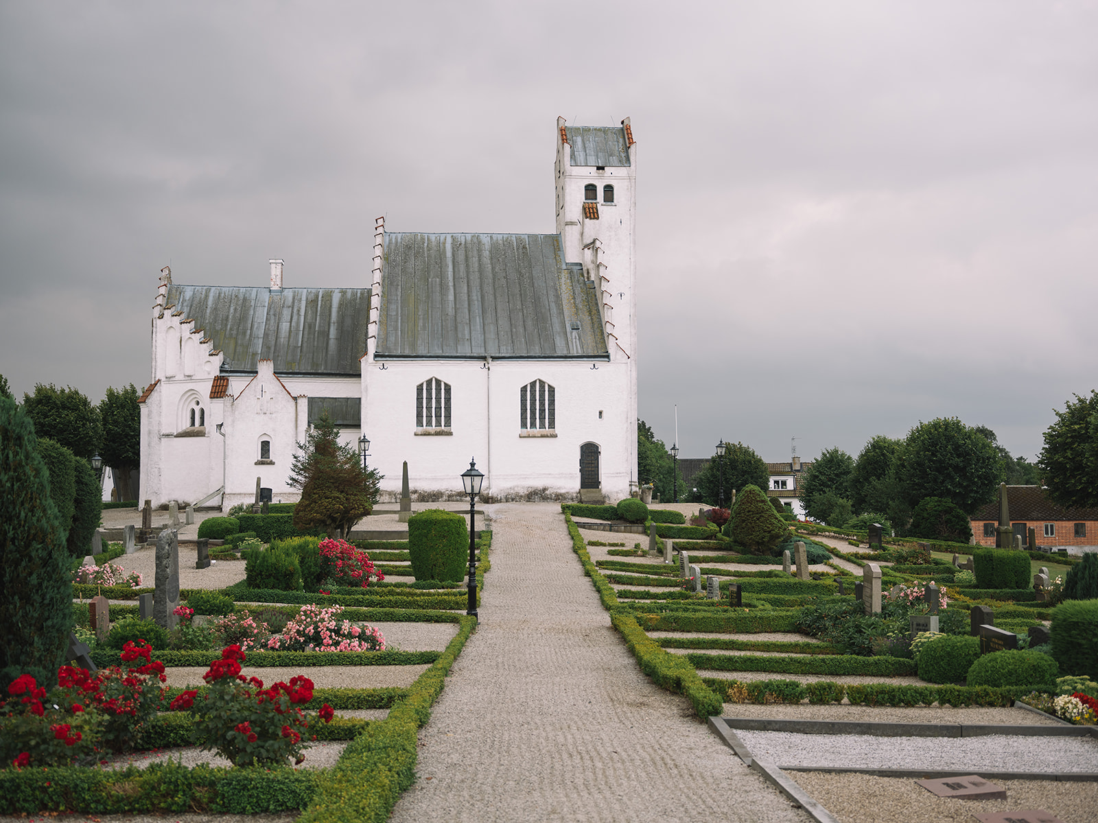 Fru Alstads kyrka and its clipped churchyard garden