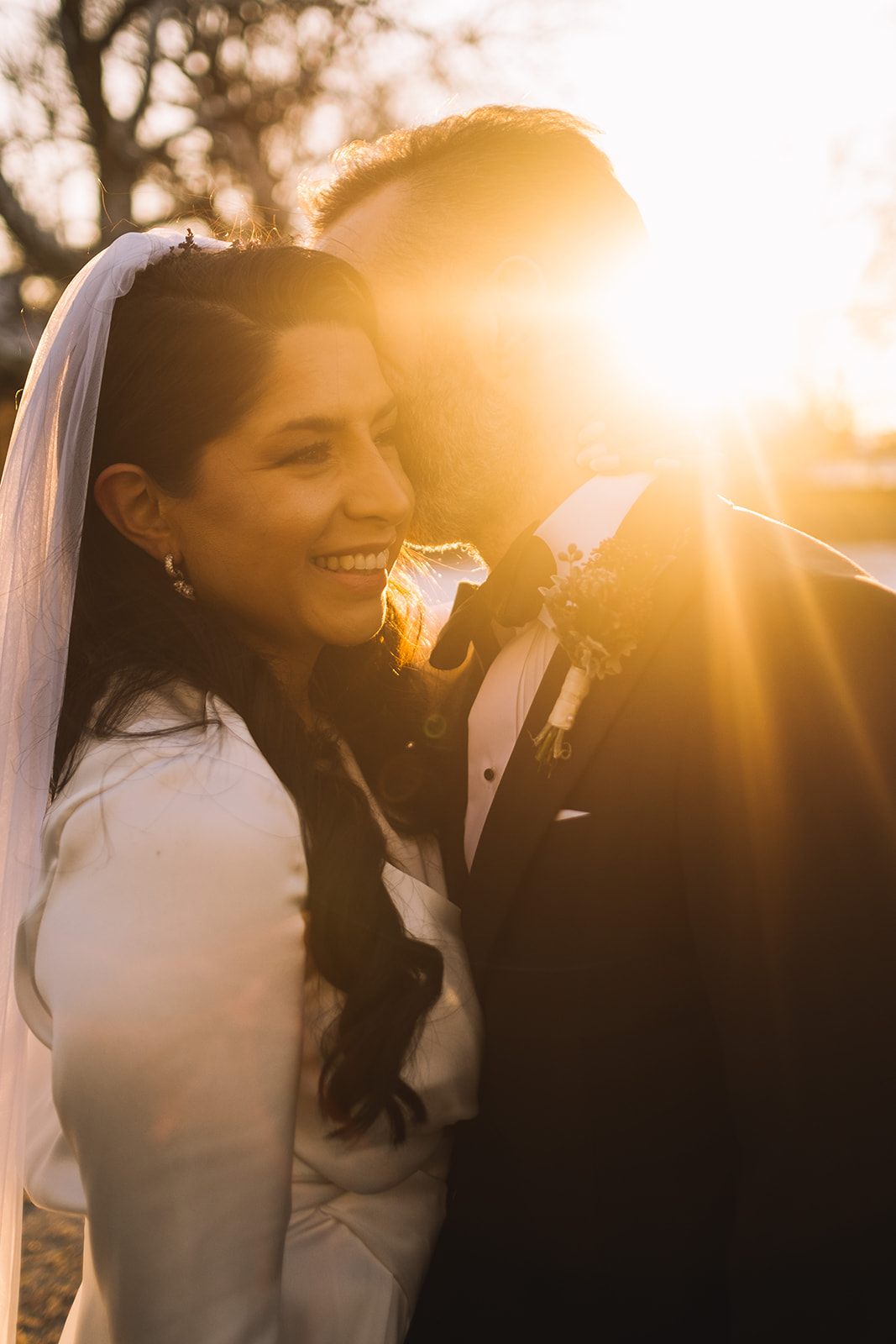 The bride laughing in the last of the winter sun