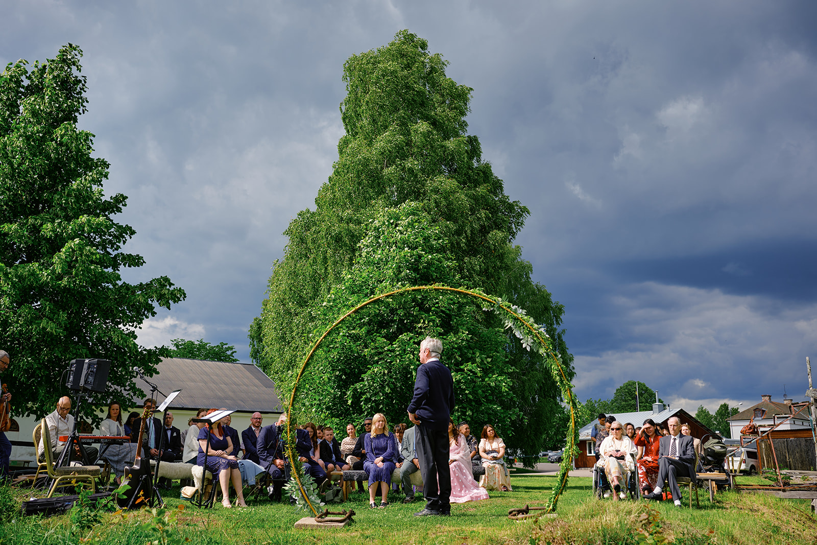 The ceremony by the Dal&auml;lven under a round floral arch