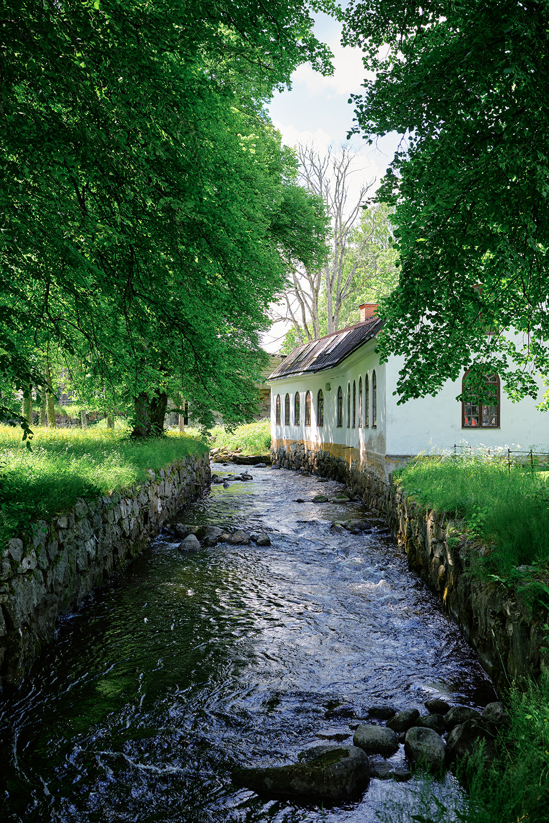 The millrace running past the wooden buildings of Gysinge bruk