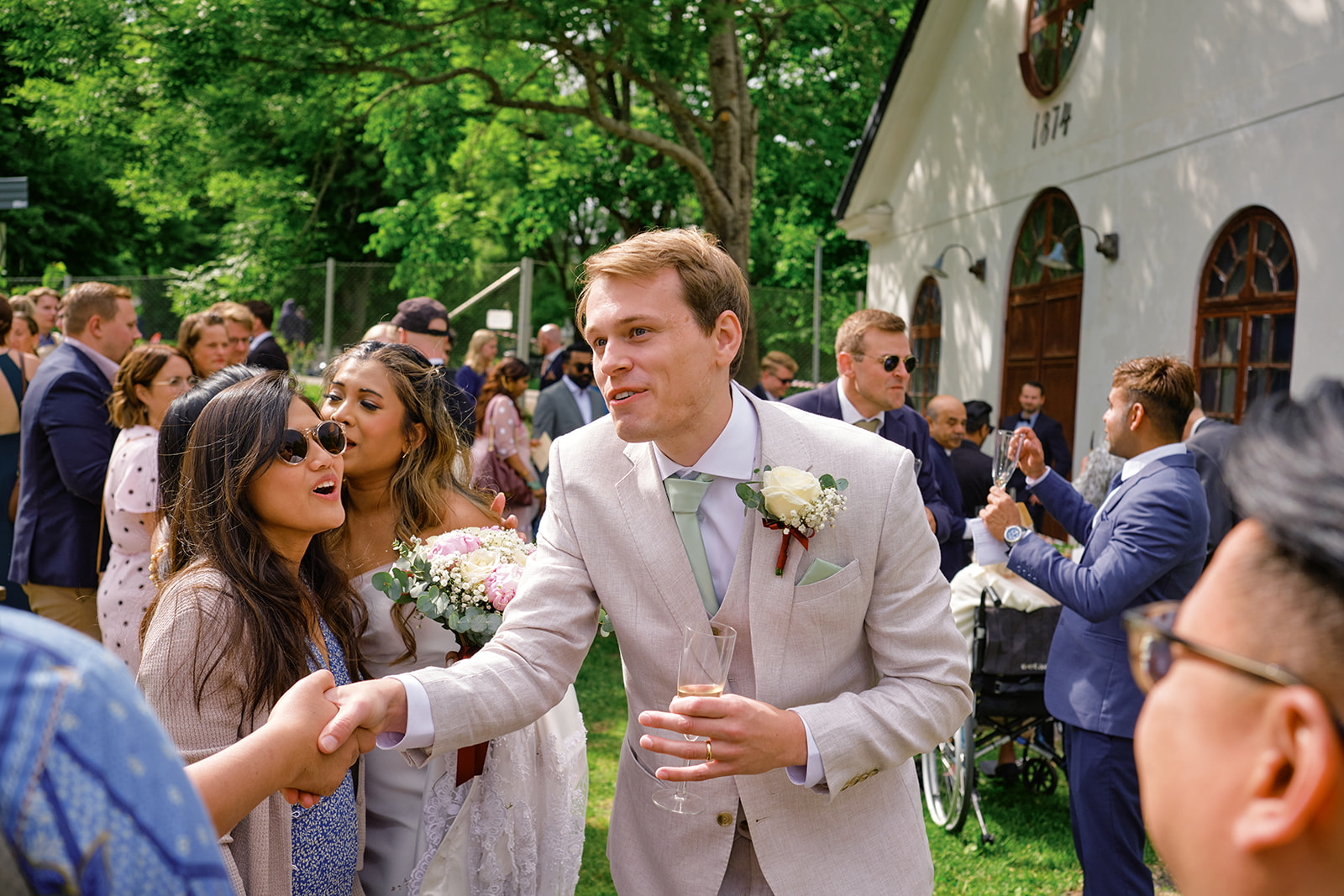 Guests congratulating the couple outside the manor