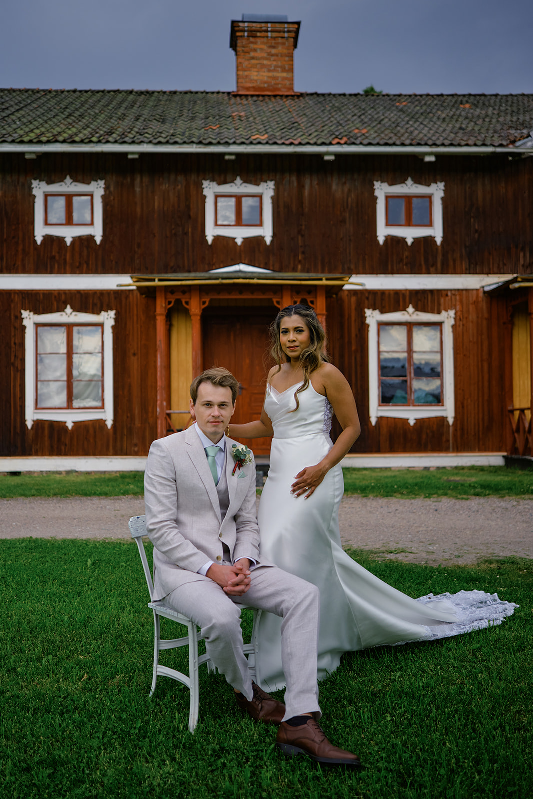 Bride and groom in front of the manor windows