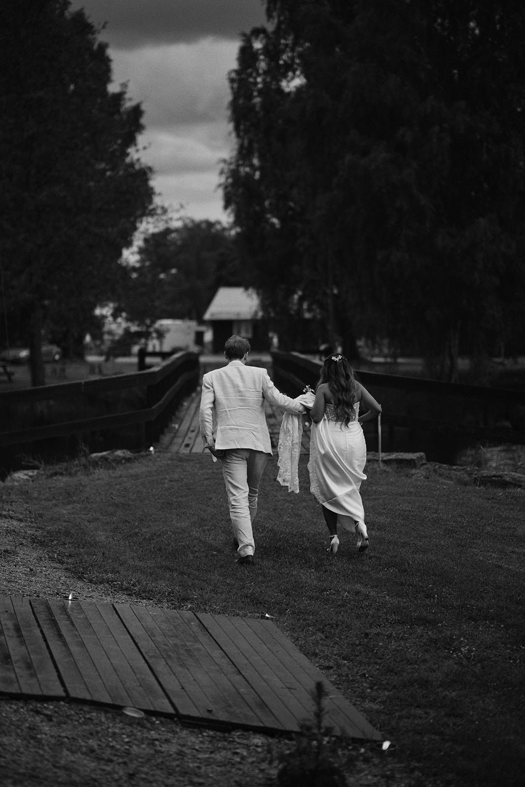 The couple on the covered bridge in the rain, black and white