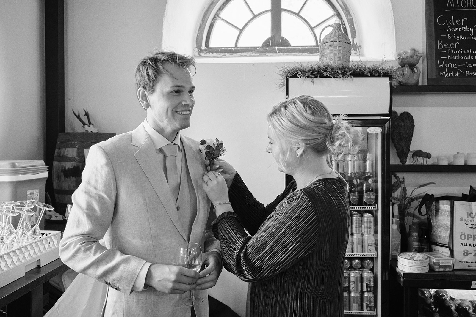 The groom having his buttonhole pinned before the ceremony