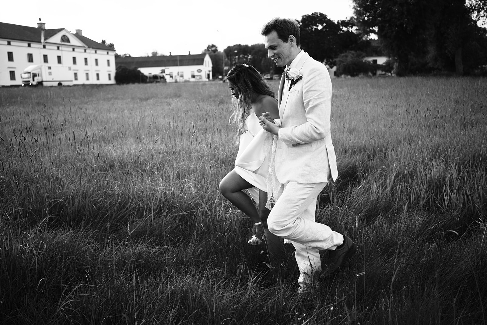 Bride and groom in the meadow below the manor, black and white