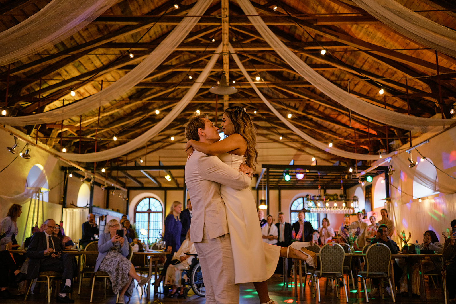 The first dance under the wooden ceiling of the manor ballroom