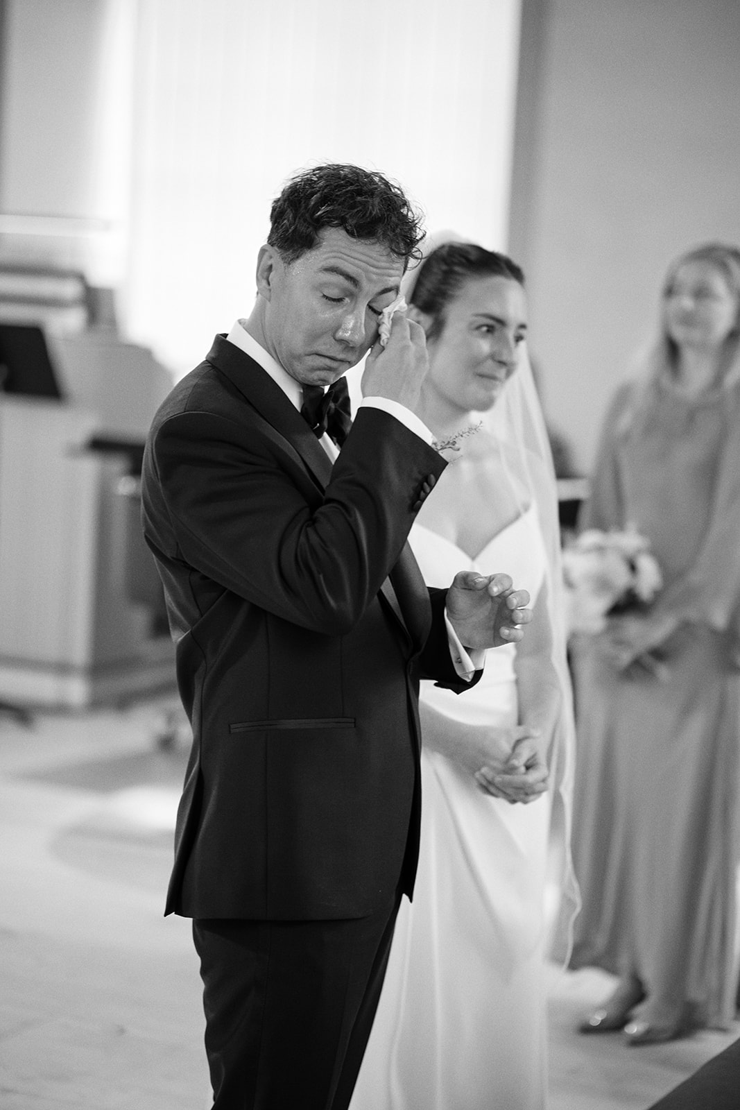 The groom during the ceremony, black and white