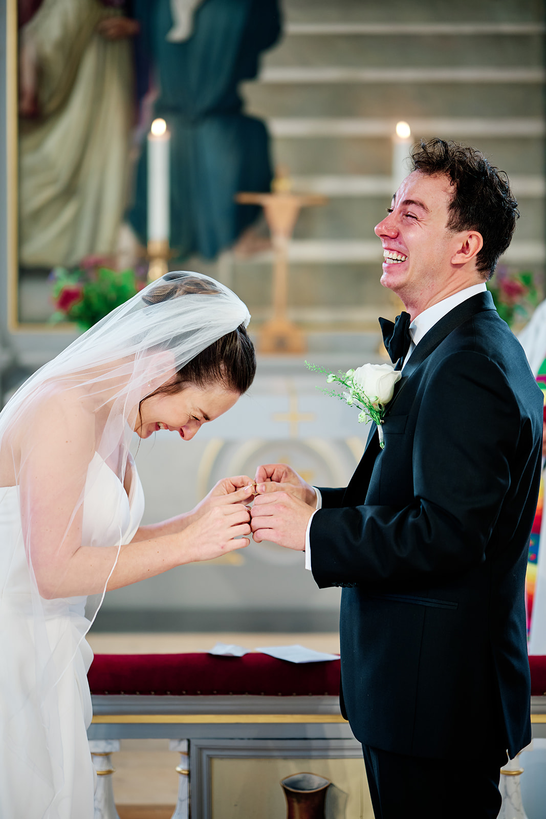 The bride laughing during the vows at Sl&auml;ps kyrka